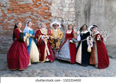 People In Medieval Clothes Represent  King Henry VIII Of England And His Six Wives. Festival Of Retro Costumes And Historical Reconstructions. History Of The Middle Ages