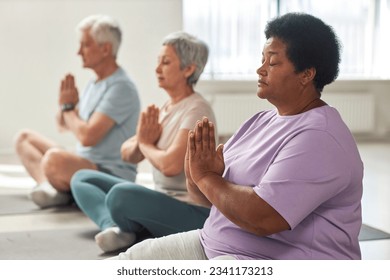 People meditating in lotus position - Powered by Shutterstock