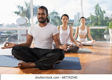 People meditating in lotus position together