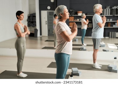 People meditating together in yoga class - Powered by Shutterstock