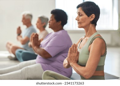 People meditating in yoga class - Powered by Shutterstock