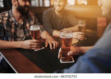 People, Men, Leisure, Friendship And Communication Concept - Close Up Of Happy Male Friends Drinking Draft Beer At Bar Or Pub