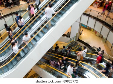 People In Motion In Escalators At The Modern Shopping Mall.