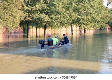 People in a motor boat ride down the flooded Houston street. Consequences of the Hurricane Harvey, Texas, USA