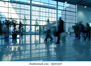  People moving in glass corridor