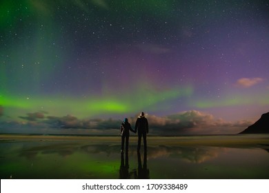 People On The Beach And Aurora In Norway, Lofoten Islands