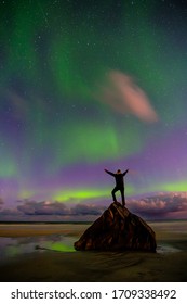 People On The Beach And Aurora In Norway, Lofoten Islands