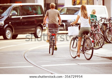 People on bikes in traffic