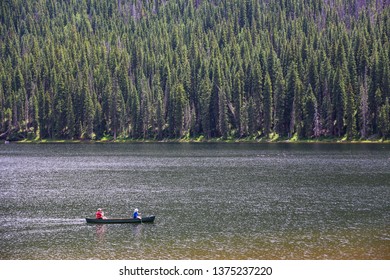 People On A Canoe In A Lake In The Colorado Rocky Mountains Of Vail In Summer At Calm Piney Lake