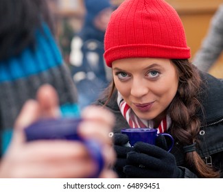 People on a Christmas market drinking punch or hot spiced wine, it is cold and they have a need to warm up - Shutterstock ID 64893451