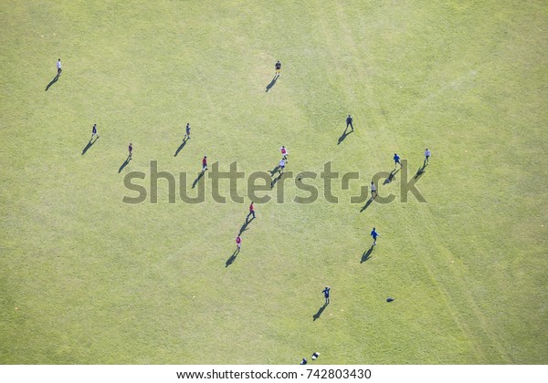 people on the green field\
from above 