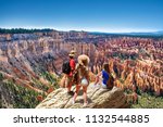 People on  hiking trip. Family on top of  mountain enjoying time together, looking at beautiful view. Inspiration Point, Bryce Canyon National Park, Utah, USA