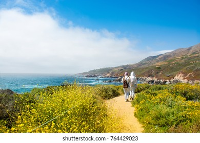 People on hiking trip  in the  mountains, walking  along Pacific Ocean coastline.  Girls on summer vacation hiking trip. Garrapata State Park and beach, Big Sur, California, USA - Powered by Shutterstock