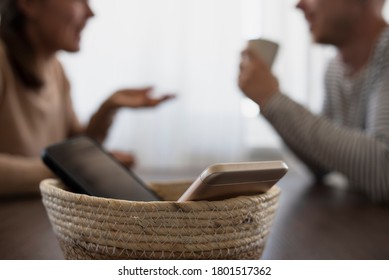 People on meeting without their phones. Digital detox concept. Turned off phones putting in basket - Shutterstock ID 1801517362
