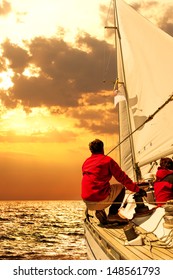 People On Sailing Boat In The Sea At Sunset 