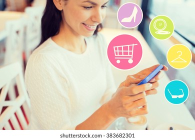 people, online shopping, technology and lifestyle concept - smiling young woman with smartphone and internet icons at cafe