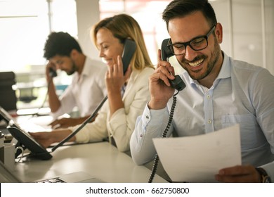 People in operations center  talking on Landline phone. Operators in the office.   - Shutterstock ID 662750800