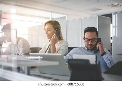 People In Operations Center  Talking On Landline Phone. Operators In The Office.  