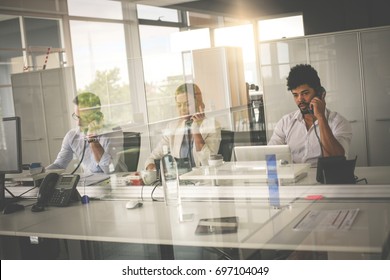 People In Operations Center  Talking On Landline Phone. Operators In The Office. 