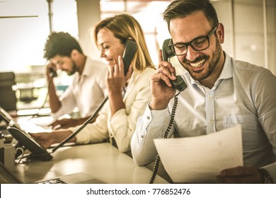 People In Operations Center  Talking On Landline Phone. Operators In The Office.