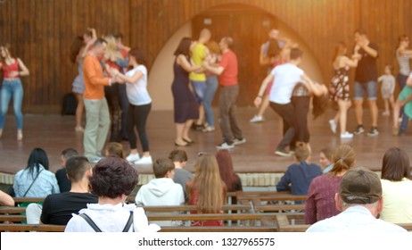 People At Outdoor Concert. People Sitting At Open Air Performance, Focus On People.