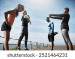 People, outdoor and stretching on road for fitness with running for exercise and workout. Friends, coast and committed or active in sportswear with warmup for health, wellbeing and self care