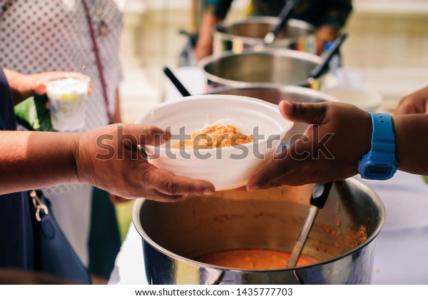 People outreach to donate food
from volunteers : Free food for poor and homeless people donates
food to food less people : Social concept of poor people
sharing.