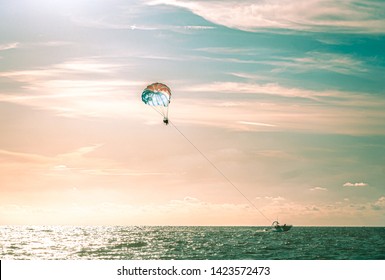People parasailing at sunset in Clearwater Beach Florida