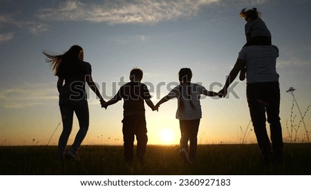 people in park silhouette. happy family kid dream holiday concept. friendly family lifestyle holding hands walking dog at sunset in the park silhouette. big family silhouette walk in the park
