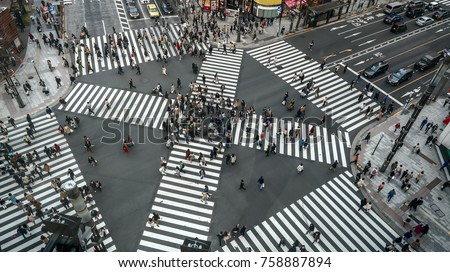 People passing the street crossing in Ginza district, Tokyo. Crosswalk. Intersection in Tokyo