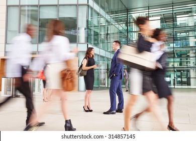 People passing through the busy foyer of a business building
