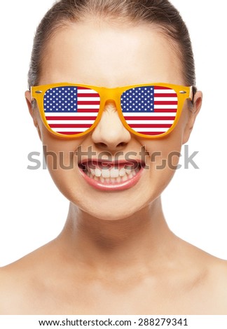 people, patriotism, national pride and independence day concept - funny teenage girl in sunglasses with american flag