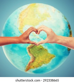 people, peace, love, life and environmental concept - close up of human hands showing heart shape gesture over earth globe and blue background - Shutterstock ID 292338665