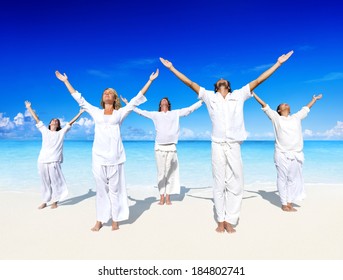 People performing yoga on the beach. - Powered by Shutterstock