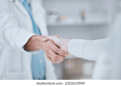 People, pharmacist and handshake in meeting, teamwork or agreement together for deal at pharmacy. Closeup of medical or healthcare team shaking hands in support, unity or thank you at the drugstore - Powered by Shutterstock