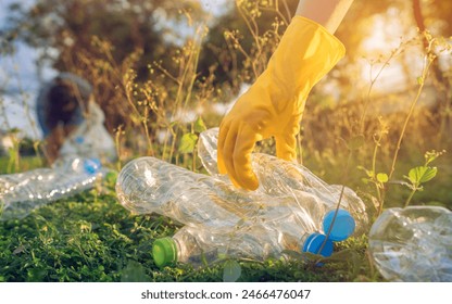  People picking plastic bottle waste at public parks. close-up  - Powered by Shutterstock