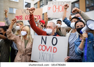 People With Placards And Posters On Public Demonstration, No Covid Vaccine Concept.