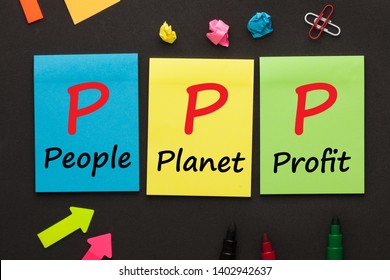 People Planet Profit (PPP) text on color notes and office supplies on black background.