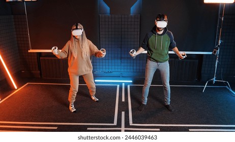 People play artificial drumming Oculus Rift VR game. Couple play virtual reality simulation. Male and female in gaming headsets musical drums competition. Music gamer person in vr glasses headset. - Powered by Shutterstock