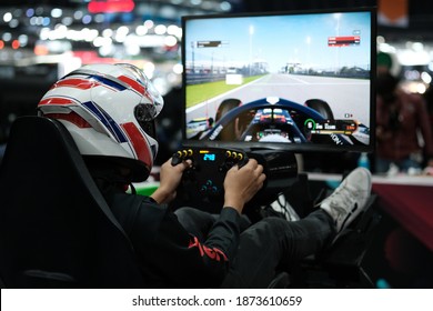 People play at Games Week, event dedicated to video games and electronic entertainment, Joy games driving gamer. (VR games) - Shutterstock ID 1873610659