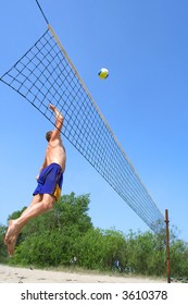 People Playing Beach Volleyball - Fat Man Jumps High To Strike The Ball. Shot Near Dnieper River, Ukraine.