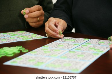 People Playing Bingo With Chips And Cards