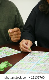 People Playing Bingo With Chips And Cards