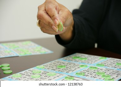 People Playing Bingo With Chips And Cards