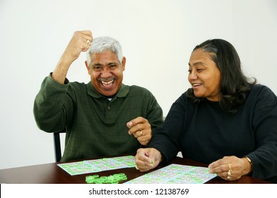 People Playing Bingo With Chips And Cards