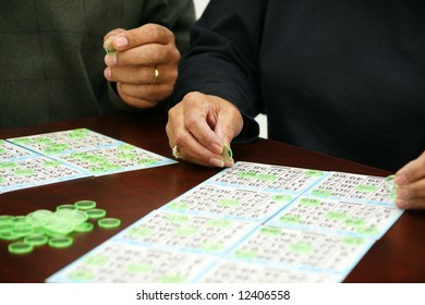 People Playing Bingo With Chips And Cards