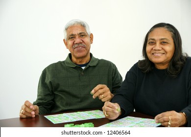 People Playing Bingo With Chips And Cards