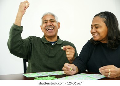 People Playing Bingo With Chips And Cards