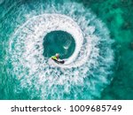 People are playing a jet ski in the sea.Aerial view. Top view.amazing nature background.The color of the water and beautifully bright. Fresh freedom. Adventure day.clear turquoise at tropical beach.