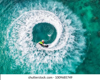 People are playing a jet ski in the sea.Aerial view. Top view.amazing nature background.The color of the water and beautifully bright. Fresh freedom. Adventure day.clear turquoise at tropical beach. - Shutterstock ID 1009685749